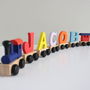 Personalised Coloured Wooden Name Train And Gift Bag, thumbnail 1 of 8