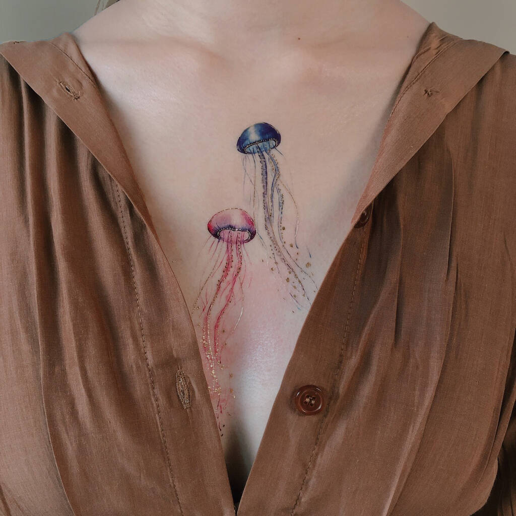 Fine line jellyfish tattoo located on the forearm.