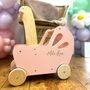 Personalised Flat Packed Pink Wooden Push Along Toy Pram, thumbnail 1 of 4