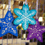 Star And Snowflake Linocut Wooden Christmas Decorations, thumbnail 1 of 5
