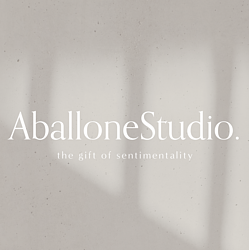 'AballoneStudio' Logo with 'print, design, lifestyle' underneath. Dark green background with beige text.