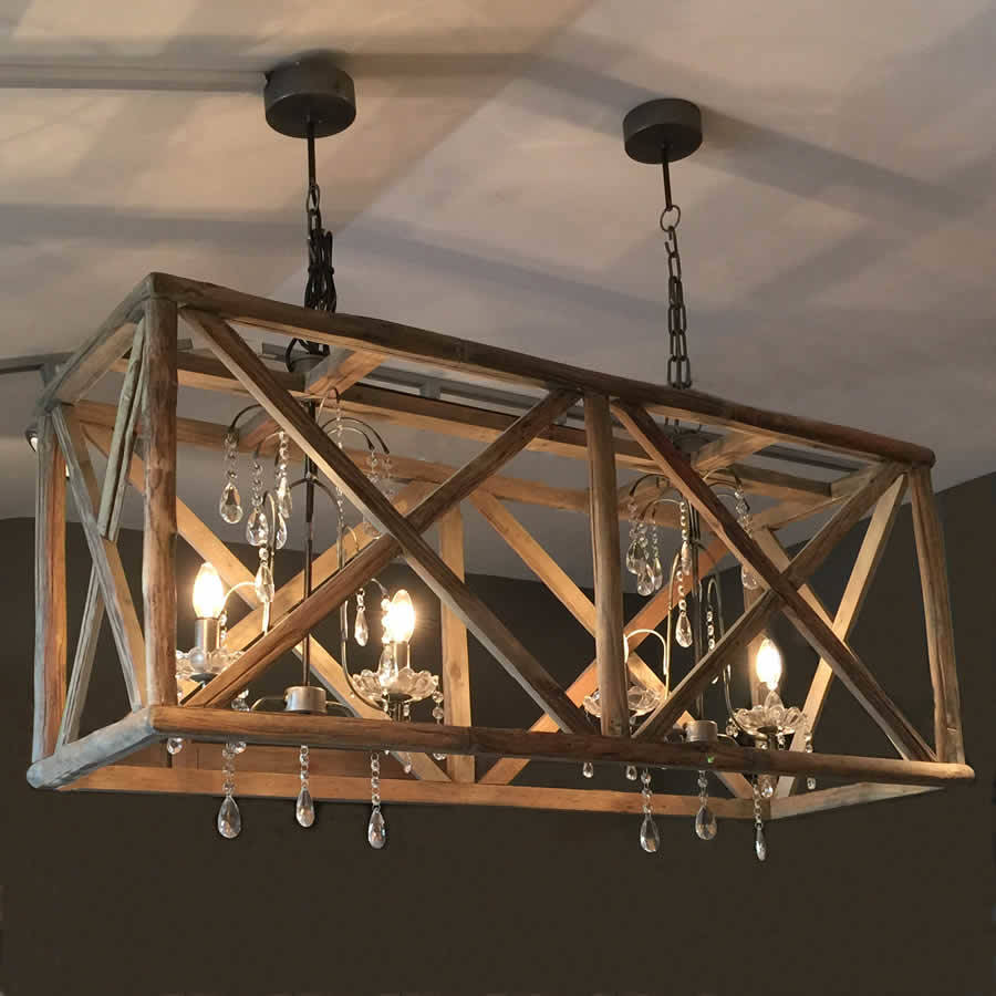large wooden chandelier with metal and crystal by cowshed