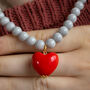 Pastel Grey Bead And Red Heart Necklace, thumbnail 1 of 7