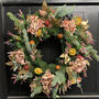 Clementine Faux Flowers Christmas Wreath, thumbnail 1 of 4