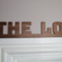 The Loo Sign: Walnut Wood Door Topper With Adhesive Dots, thumbnail 2 of 7