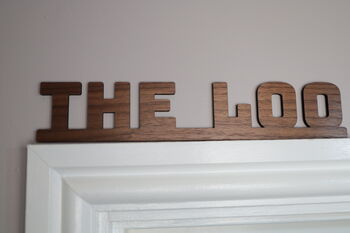 The Loo Sign: Walnut Wood Door Topper With Adhesive Dots, 2 of 7