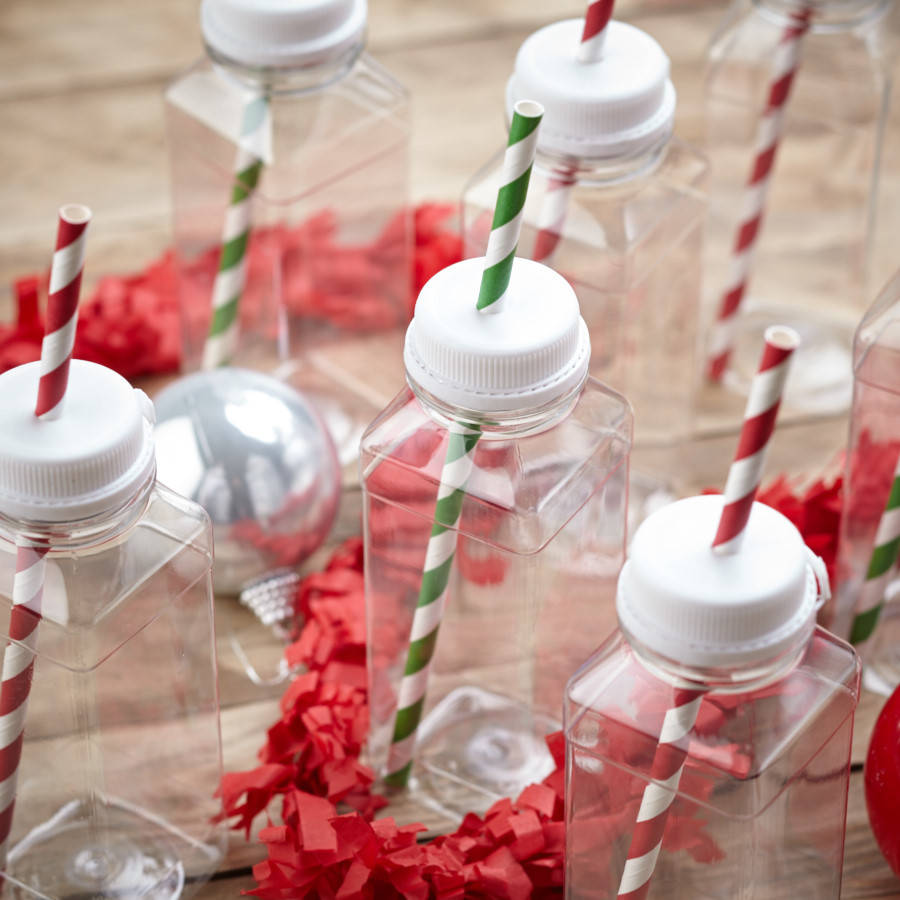 children's milk bottles by pink biscuits