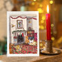 Cosy Dogs Beside The Fire Christmas Card, thumbnail 1 of 4