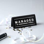 Black 'Manager Of Unnecessary Events' Desk Sign, thumbnail 1 of 2