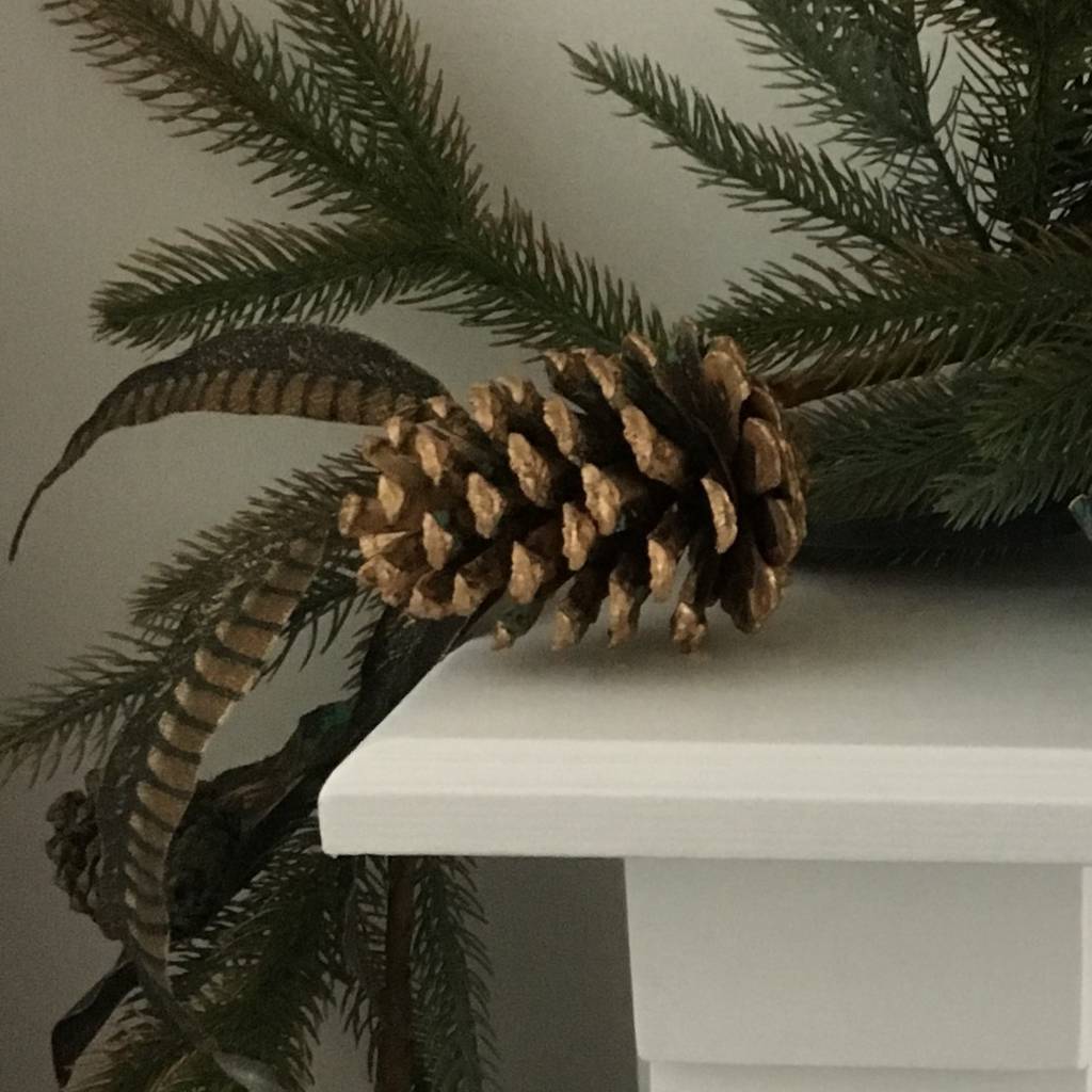 gold cone and feather christmas garland by the christmas home