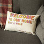 'Welcome to Our Home' Humorous Decorative Cushion, thumbnail 1 of 5