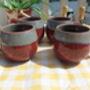 Set Of Four Reactive Glaze Sphere Mugs In Maroon And Grey Mist Haze, thumbnail 1 of 9