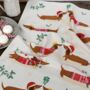 Festive Sausage Dog Tea Towel, thumbnail 1 of 3