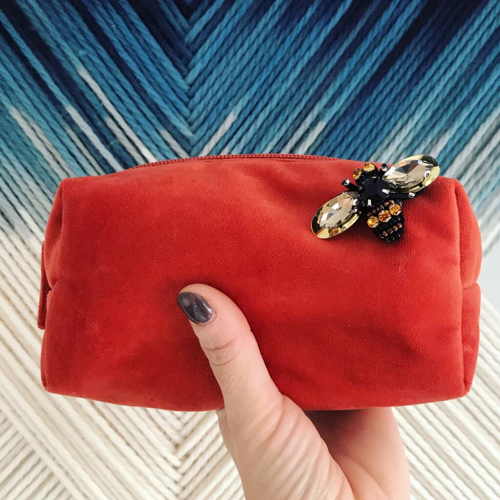 small-velvet-make-up-bag-in-coral-with-a-brooch-by-sixton-london