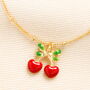 Enamel Cherry Bow Charm Bracelet In Gold Plating, thumbnail 2 of 4