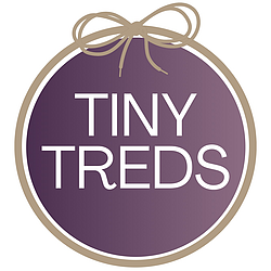Tiny Treds logo. A purple ombre circle with a gold outline and gold shoe lace ribbon.