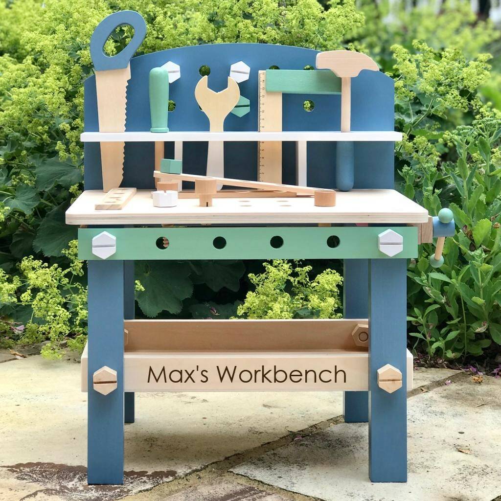 childrens wooden workbench with tools and storage rack