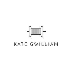Kate Gwilliam in black and white with a cotton reel and needle