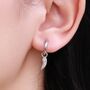 Sterling Silver Tiny Angel Wing Huggie Hoop Earrings, thumbnail 1 of 10