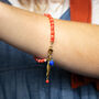 Red Candy Stripe Bead And Fish Charm Bracelet, thumbnail 2 of 5