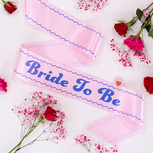 https://cdn.notonthehighstreet.com/fs/dd/c3/58a3-7738-4b8a-9878-4dcc96e9493e/preview_retro-style-personalised-bride-to-be-sash.jpg