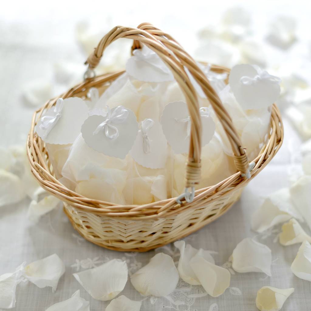 flower girl basket with white rose petal confetti by the flower studio