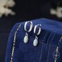 Sterling Silver Dangling Oval White Opal Hoop Earrings, thumbnail 1 of 11