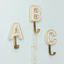 Alphabet Cream Crackle Glazed Hooks In Antique Brass, thumbnail 1 of 9