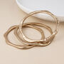 Set Of Three Gold Plated Wave Edge Bangle Bracelet Stack, thumbnail 4 of 5