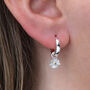 Sterling Silver Daisy Charm Huggie Hoop Earrings, thumbnail 2 of 6