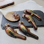 Four Hand Painted Belgian Dark Chocolate Ara Macaws, thumbnail 1 of 5