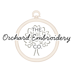 The Orchard Embroidery Company logo, featuring a line drawing of a beige wooden embroidery hoop, with a line drawn tree inside. 