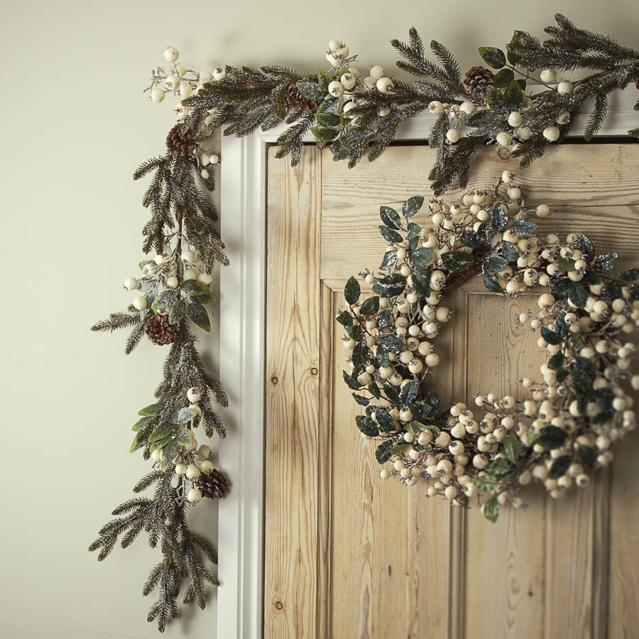 white snow berry christmas wreath or garland by the christmas home