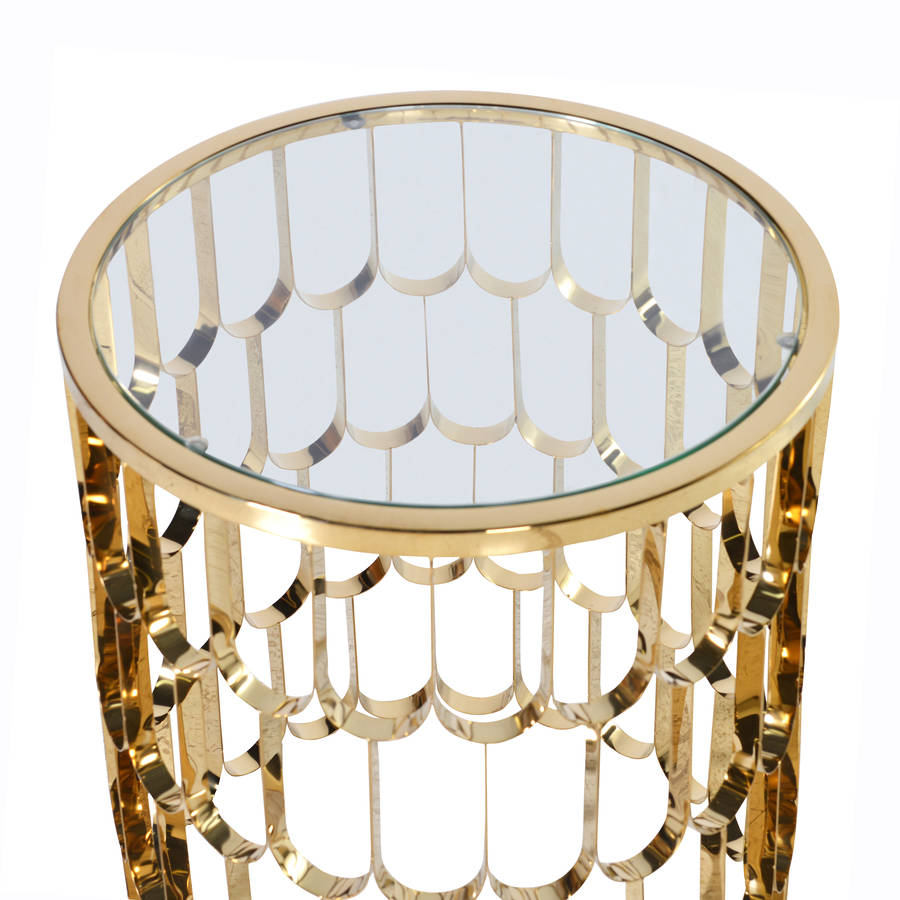 round glossy side table in gold by out there interiors