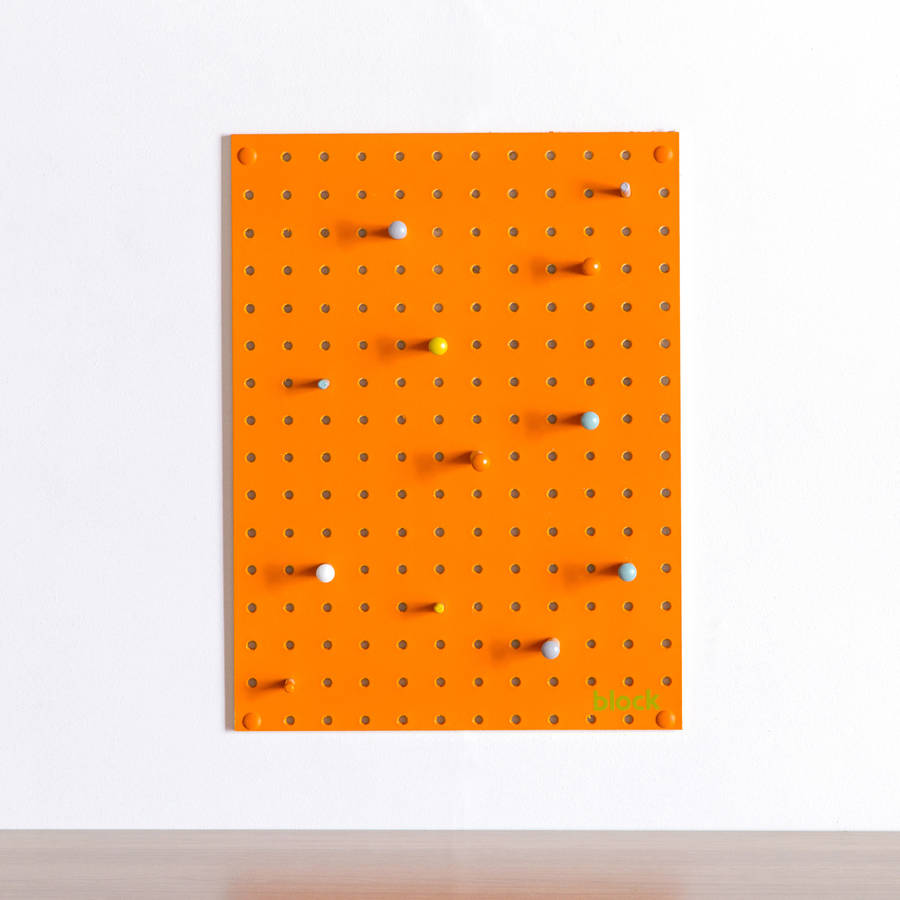 orange pegboard with wooden pegs, small by block
