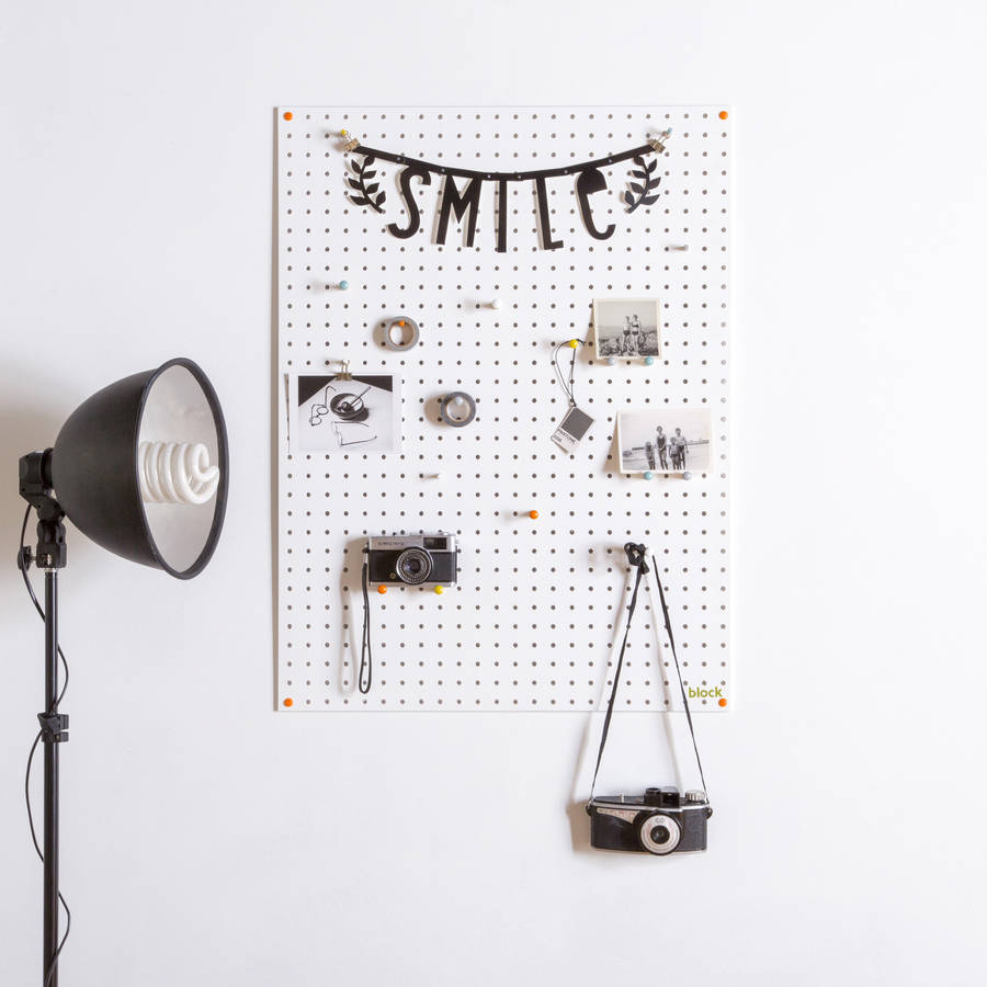 white pegboard with wooden pegs, large by block design