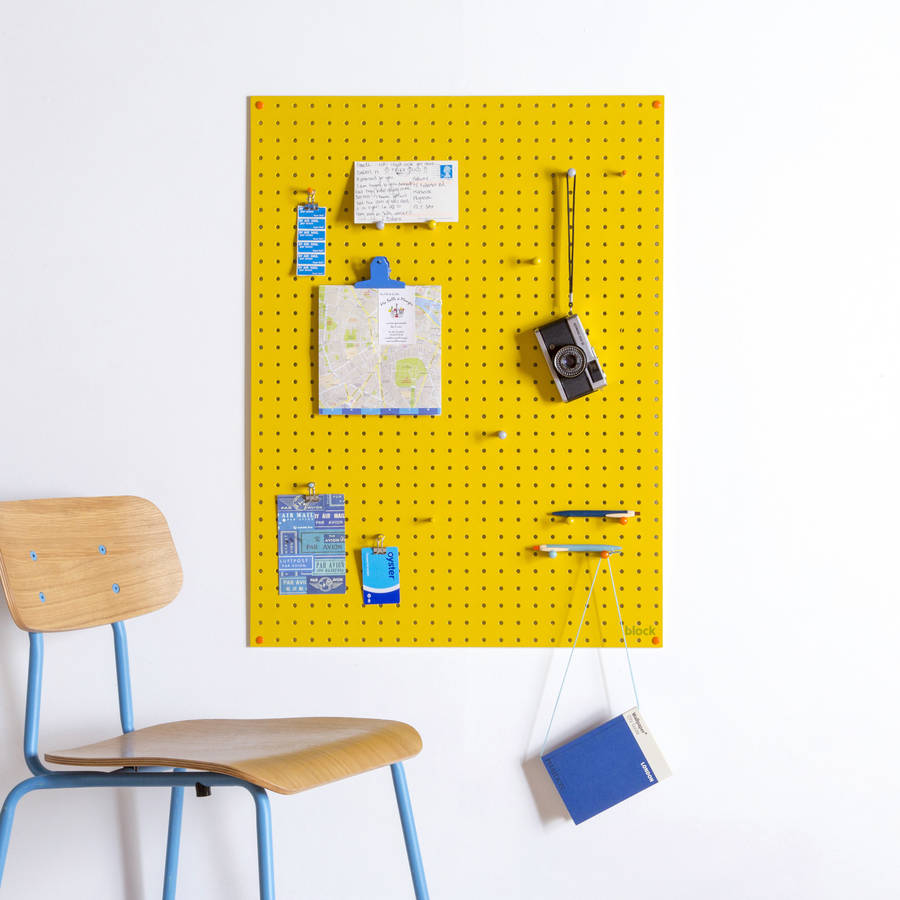yellow pegboard with wooden pegs, large by block design